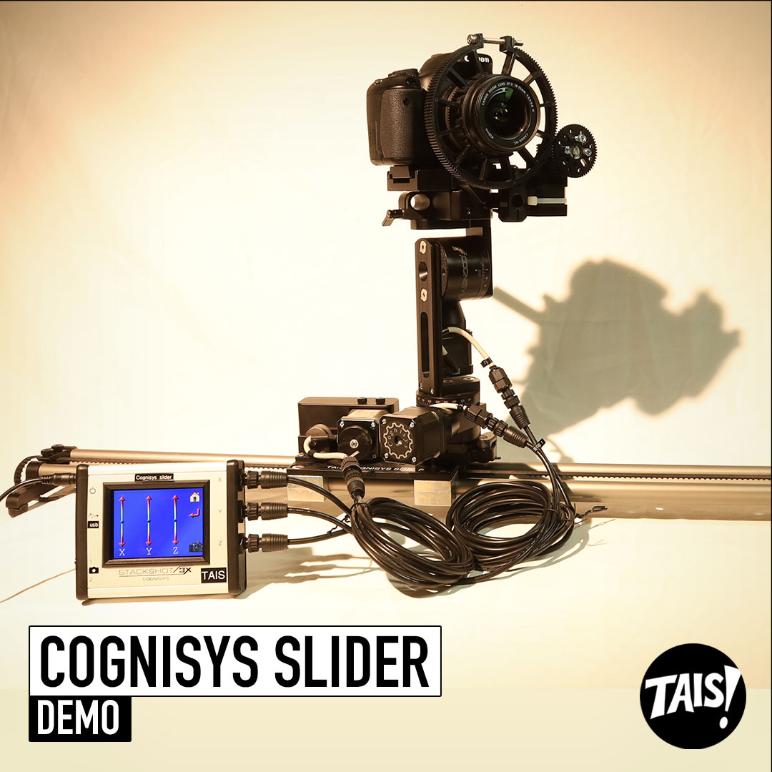 A camera is mounted onto 3 motors. the motors are mounted onto a rail system. The Cognisys machine is in the studios, with a white background.